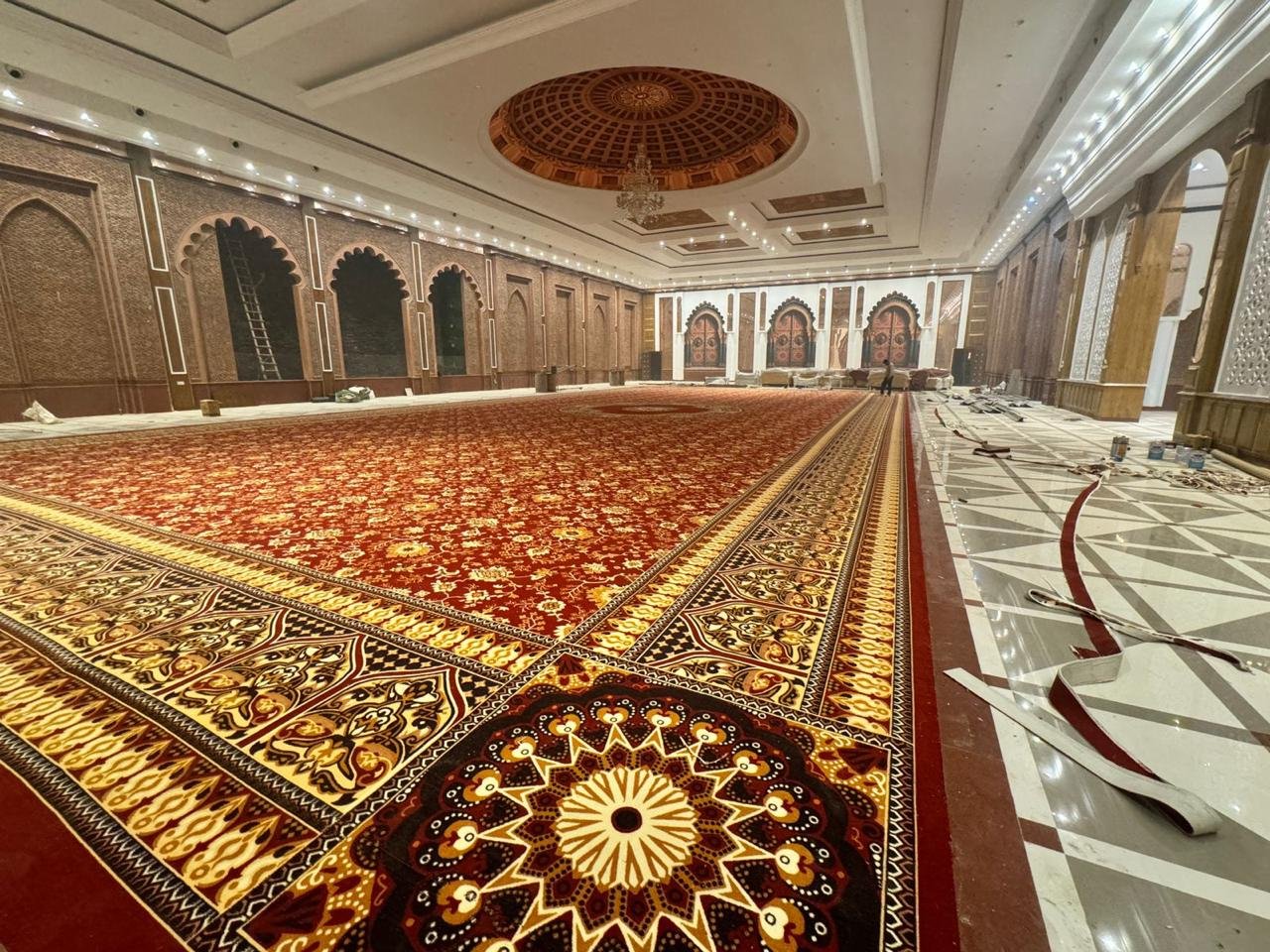 Traditional red carpet flooring in Ahmedabad – premium custom rug installation for large halls, weddings, and hotels.