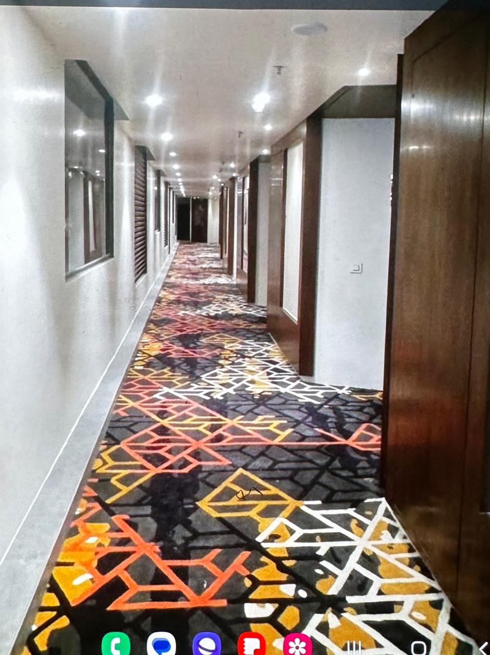 Hotel corridor colorful carpet installation in Ahmedabad – custom patterned rug design for premium hospitality interiors.
