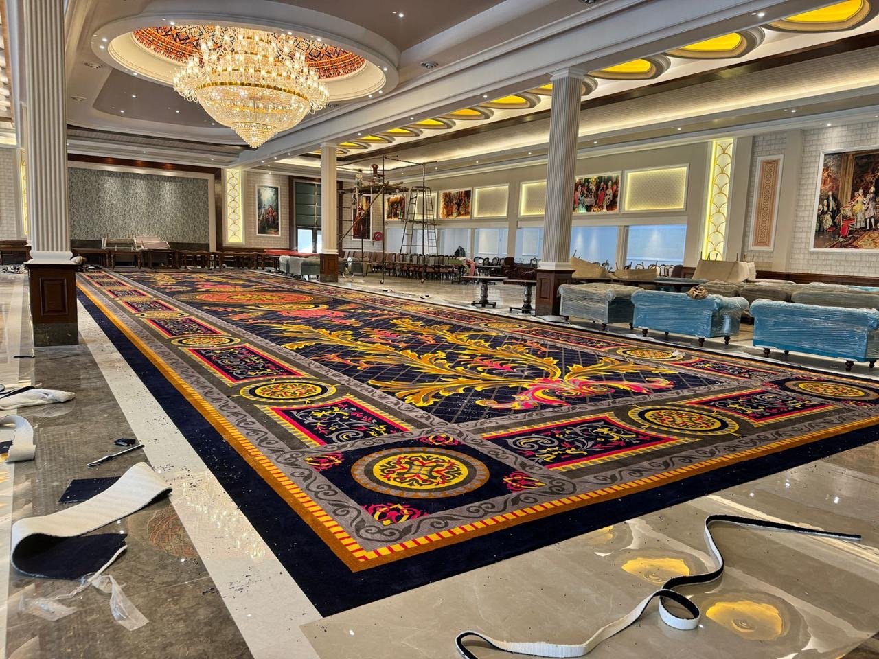 Luxury banquet hall carpet installation in Udaipur – premium custom hand-tufted royal rug for hotels and event venues.